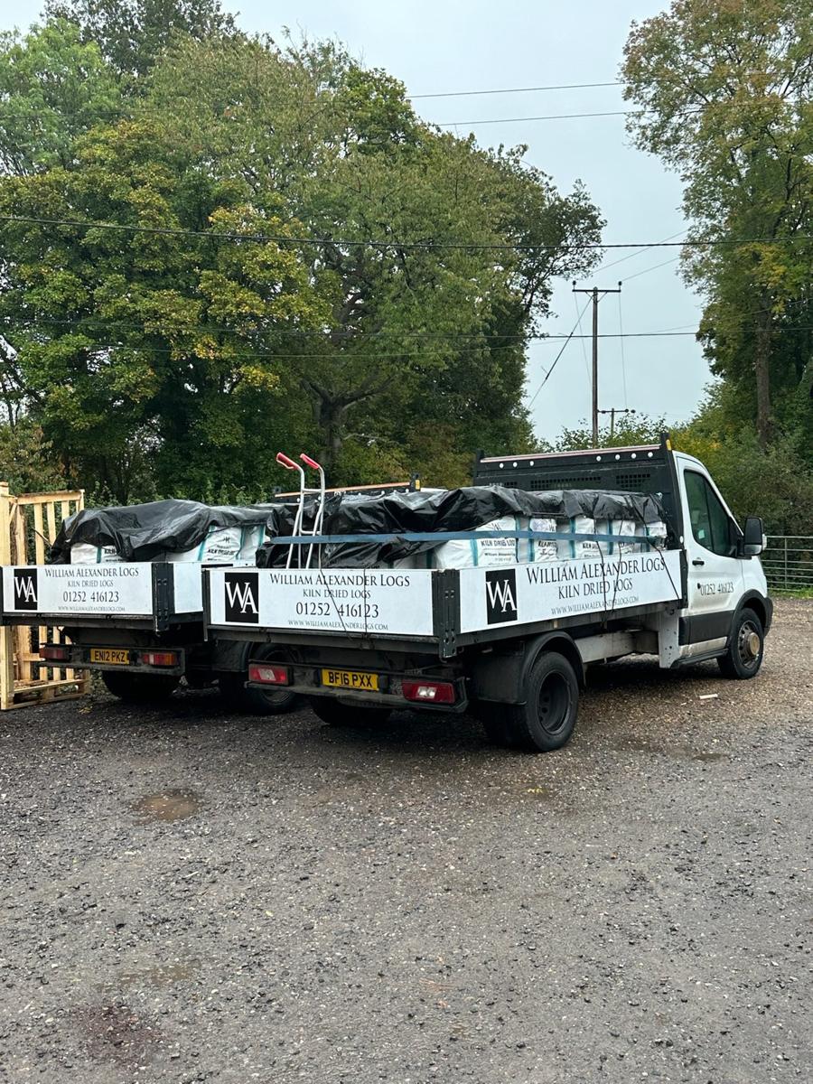 The two William Alexander delivery vans loaded with barrow bags at the yard